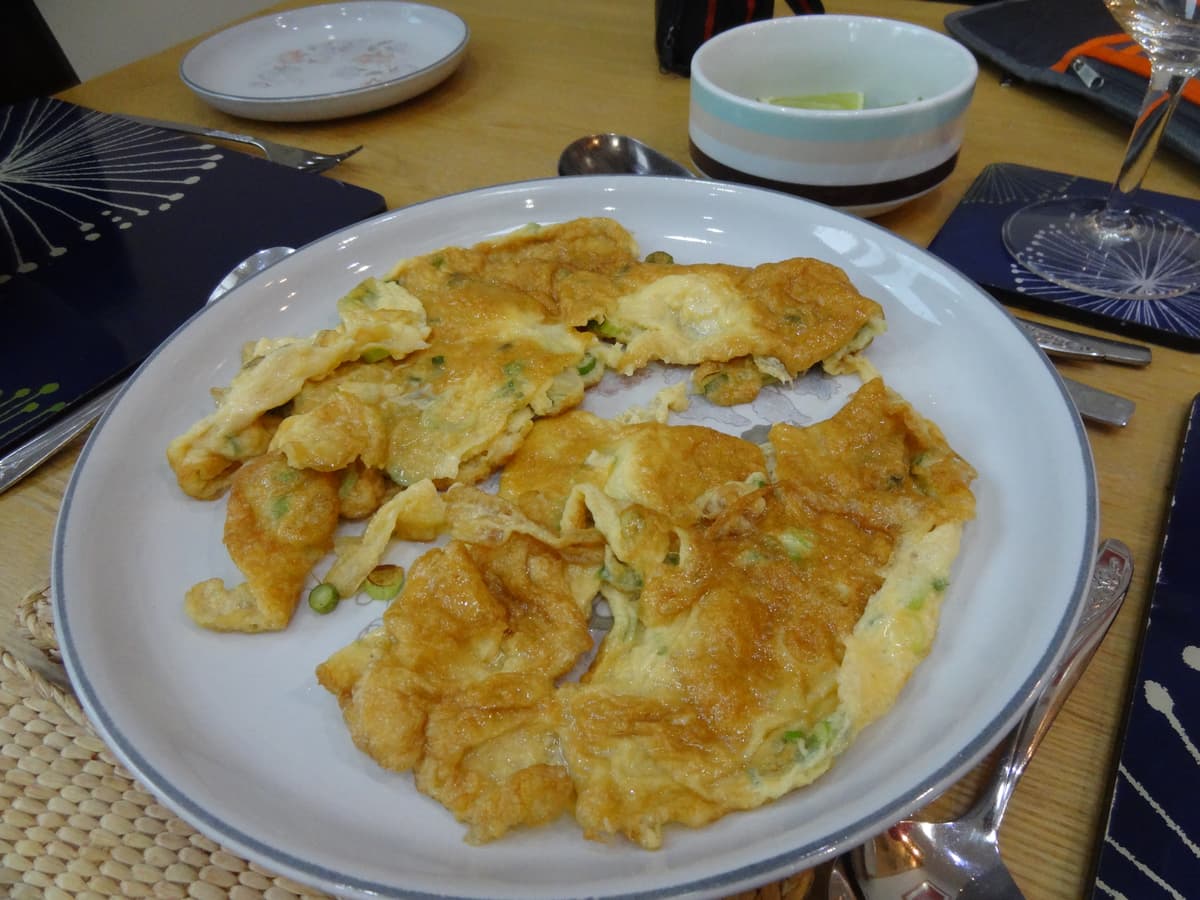 A Thai sharing dinner spread with multiple dishes on a table
